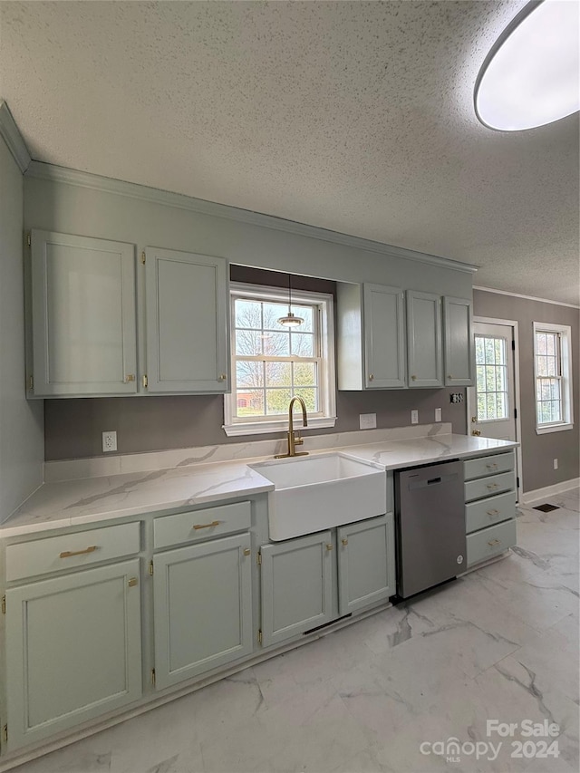 kitchen featuring dishwasher, a textured ceiling, a wealth of natural light, and sink