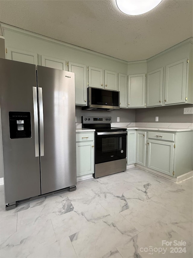 kitchen with a textured ceiling and appliances with stainless steel finishes