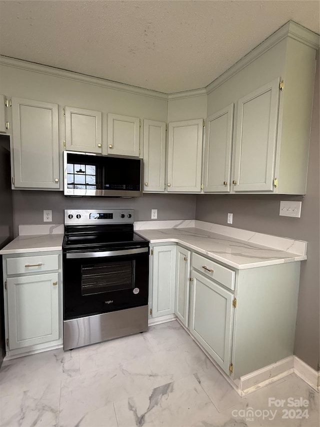 kitchen featuring crown molding, a textured ceiling, and appliances with stainless steel finishes