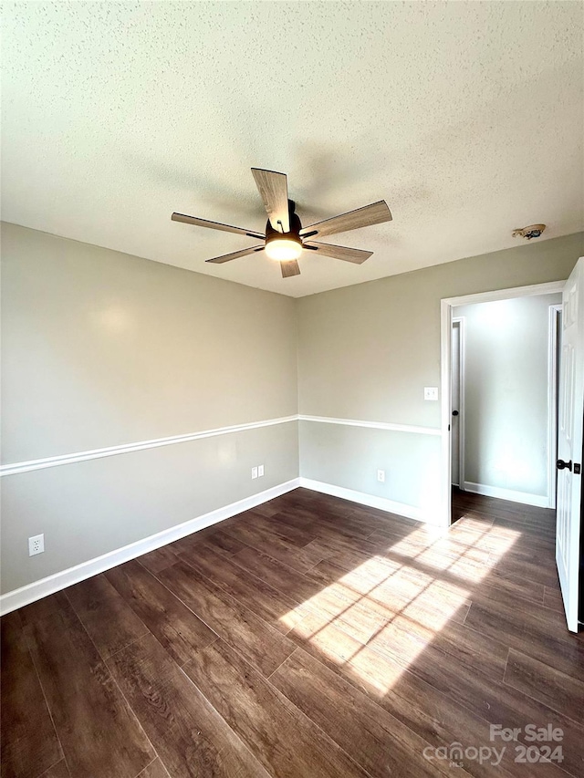 empty room featuring hardwood / wood-style floors, ceiling fan, and a textured ceiling