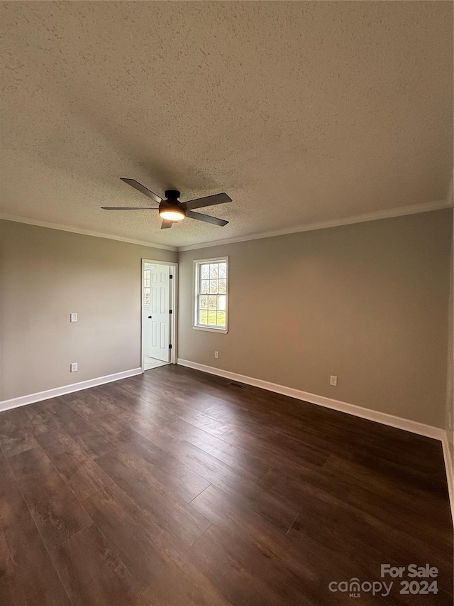 empty room featuring a textured ceiling, crown molding, ceiling fan, and dark wood-type flooring