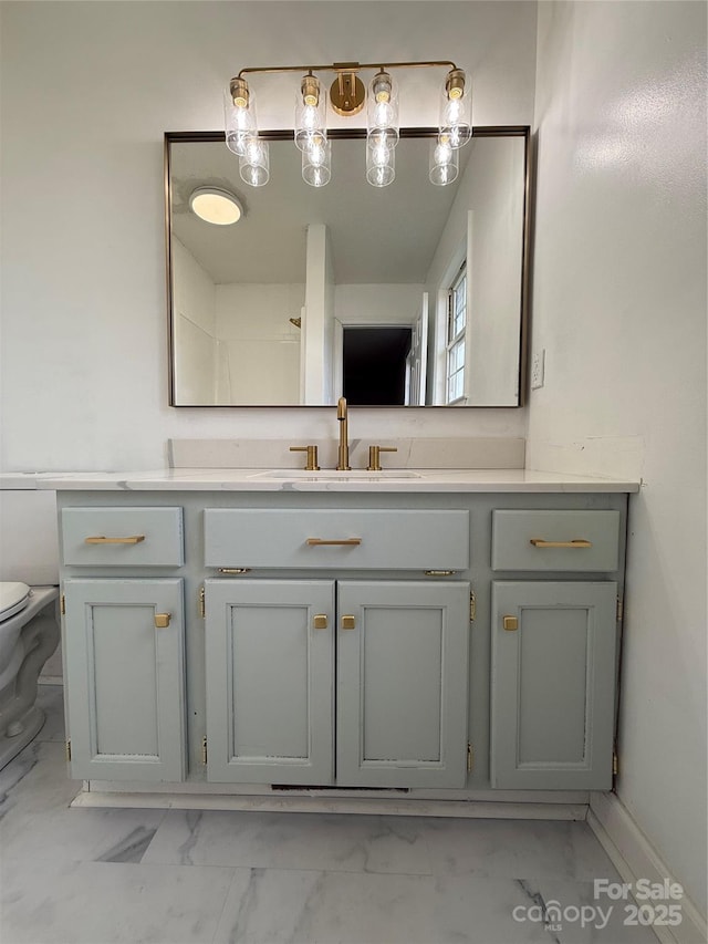 bathroom with vanity and toilet