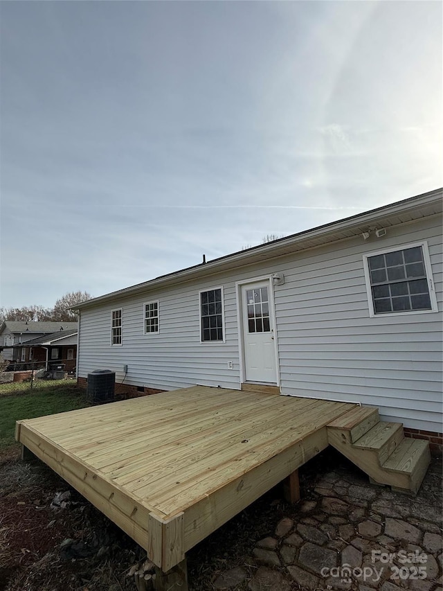 back of house with a wooden deck and central air condition unit