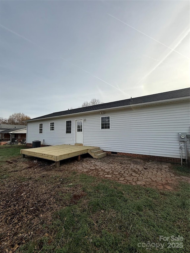 back of house featuring a wooden deck