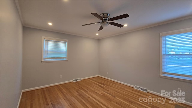 unfurnished room featuring ornamental molding, light hardwood / wood-style floors, ceiling fan, and plenty of natural light