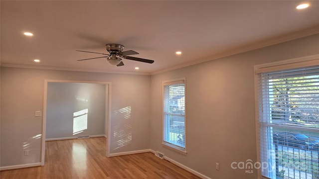 empty room featuring crown molding, ceiling fan, and light hardwood / wood-style flooring