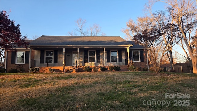 ranch-style home with a front yard and a porch