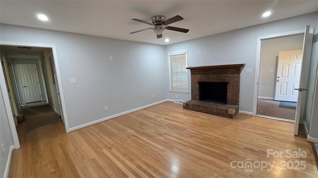 unfurnished living room with recessed lighting, a brick fireplace, ceiling fan, and light wood-style flooring