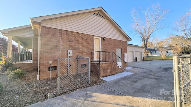 view of home's exterior featuring a garage and brick siding