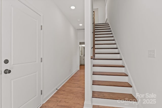 staircase featuring hardwood / wood-style floors