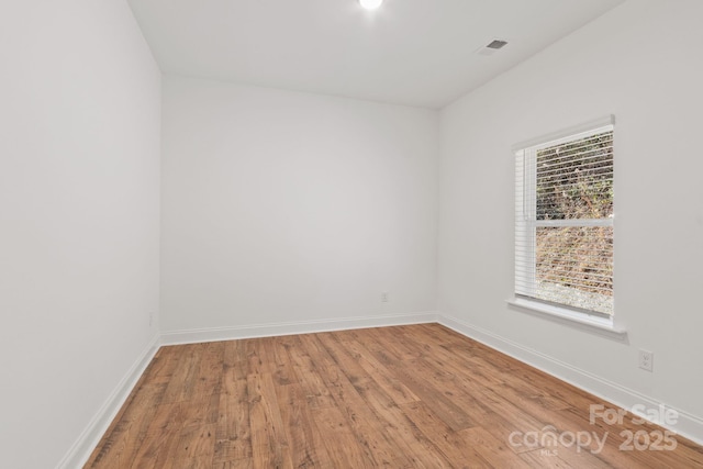 unfurnished room featuring hardwood / wood-style floors