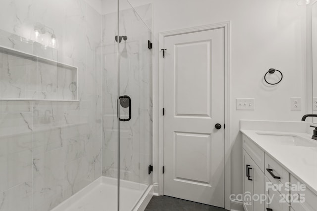 bathroom with vanity and a shower with shower door