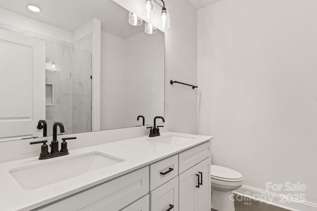 bathroom with vanity, toilet, and an enclosed shower