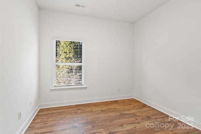 spare room featuring hardwood / wood-style flooring