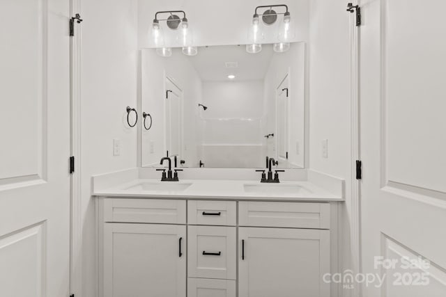 bathroom featuring vanity and walk in shower