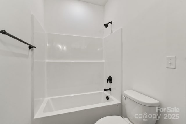 bathroom featuring bathtub / shower combination and toilet