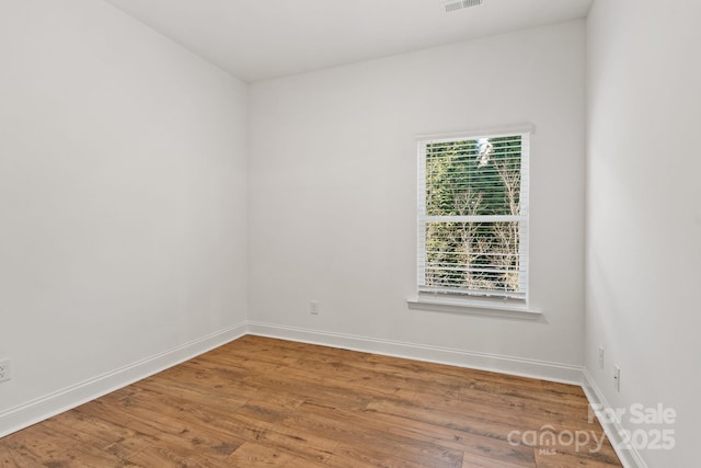 spare room featuring hardwood / wood-style flooring