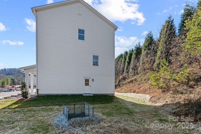 view of side of home with a yard