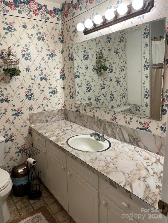 bathroom with walk in shower, tile patterned flooring, vanity, and toilet