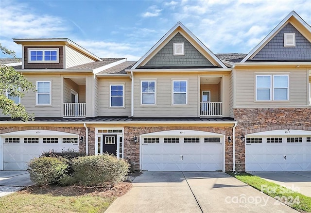 view of front of home with a balcony and a garage