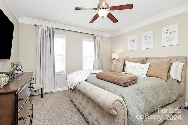 carpeted bedroom with ceiling fan and ornamental molding