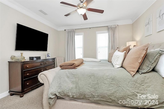 carpeted bedroom with ceiling fan and ornamental molding