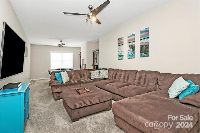 carpeted living room with ceiling fan