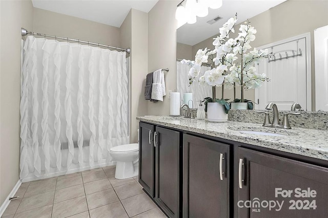 full bathroom featuring tile patterned flooring, vanity, shower / bath combo, and toilet