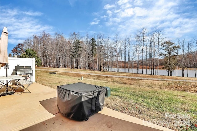 view of yard featuring a patio and a water view