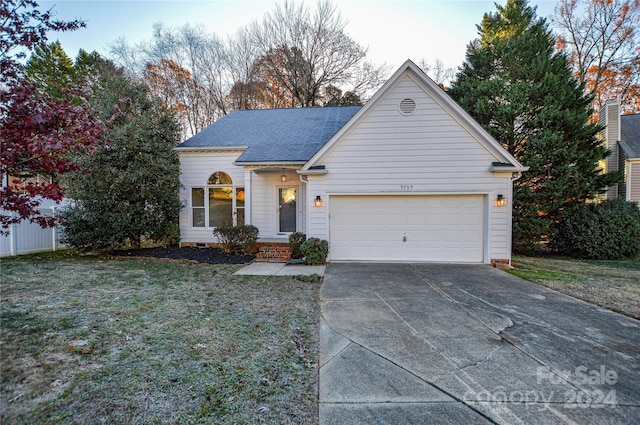 view of front of house featuring a front yard and a garage