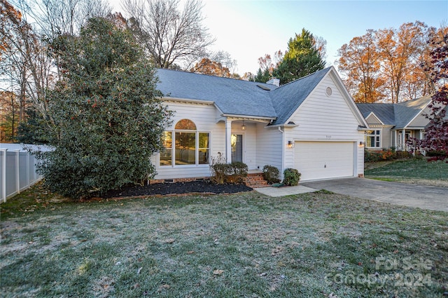 view of front of property with a garage and a front lawn