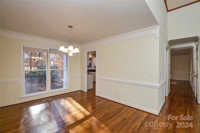 unfurnished dining area featuring a chandelier, dark wood-type flooring, and ornamental molding