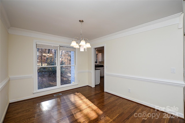 unfurnished dining area with dark hardwood / wood-style flooring, crown molding, and a chandelier