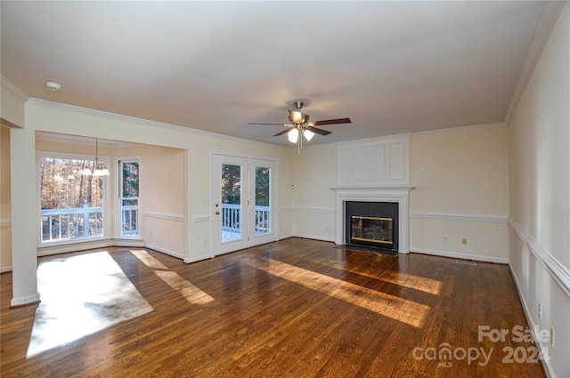 unfurnished living room featuring a large fireplace, crown molding, plenty of natural light, and dark hardwood / wood-style floors