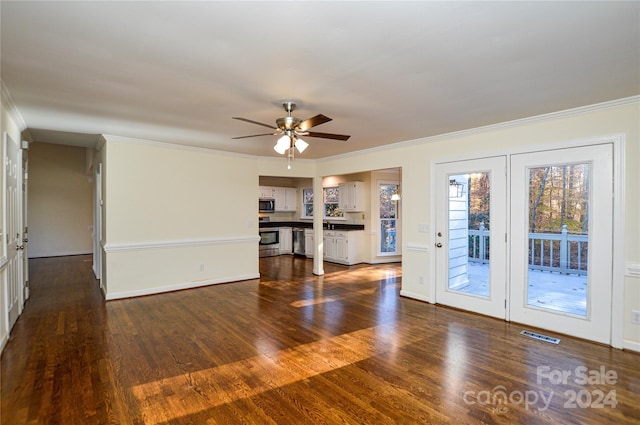 unfurnished living room with crown molding, ceiling fan, and dark wood-type flooring