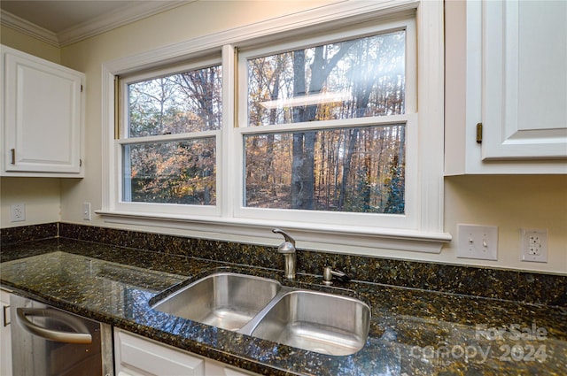 kitchen featuring dark stone counters, crown molding, sink, dishwasher, and white cabinetry