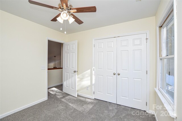 unfurnished bedroom featuring ceiling fan, a closet, and carpet