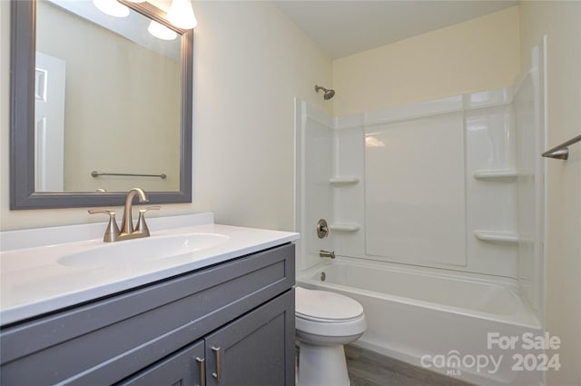 full bathroom featuring shower / washtub combination, vanity, wood-type flooring, and toilet