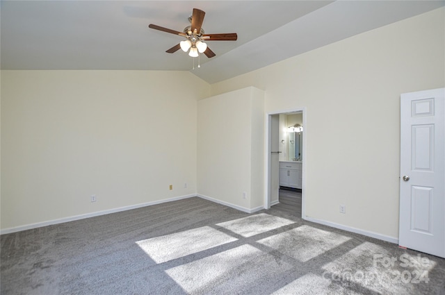 unfurnished bedroom with ceiling fan, light colored carpet, lofted ceiling, and ensuite bathroom