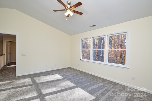 carpeted empty room with ceiling fan and lofted ceiling