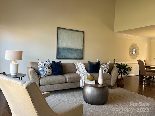 living room featuring hardwood / wood-style flooring and crown molding