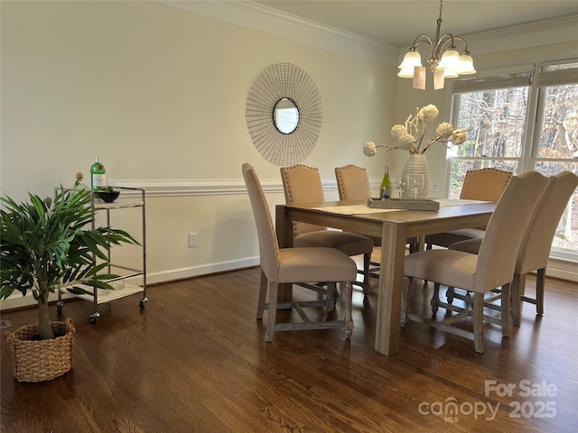 dining area featuring dark hardwood / wood-style flooring, ornamental molding, and a chandelier