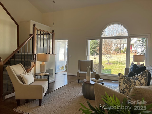 living room featuring hardwood / wood-style flooring and high vaulted ceiling