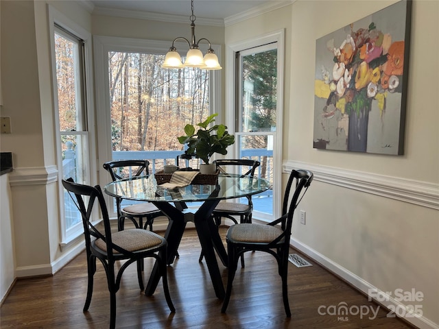 dining area with crown molding, an inviting chandelier, and dark hardwood / wood-style flooring