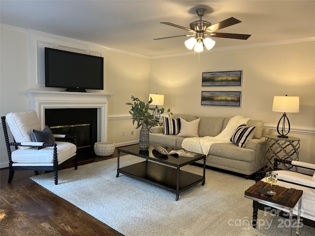 living room with crown molding, ceiling fan, and hardwood / wood-style floors