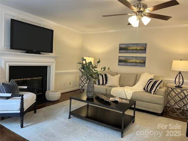 living room with hardwood / wood-style floors, crown molding, and ceiling fan