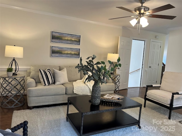 living room with hardwood / wood-style flooring, crown molding, and ceiling fan