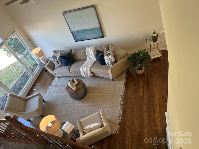 unfurnished living room featuring ceiling fan and hardwood / wood-style floors