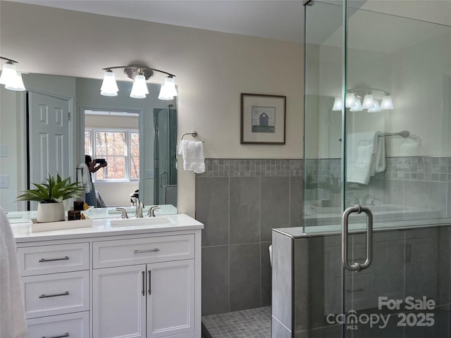 bathroom with vanity and a shower with shower door