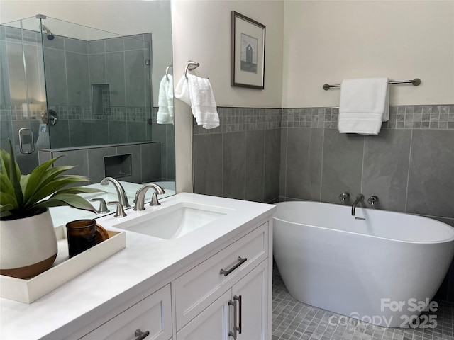 bathroom featuring tile walls, vanity, and plus walk in shower